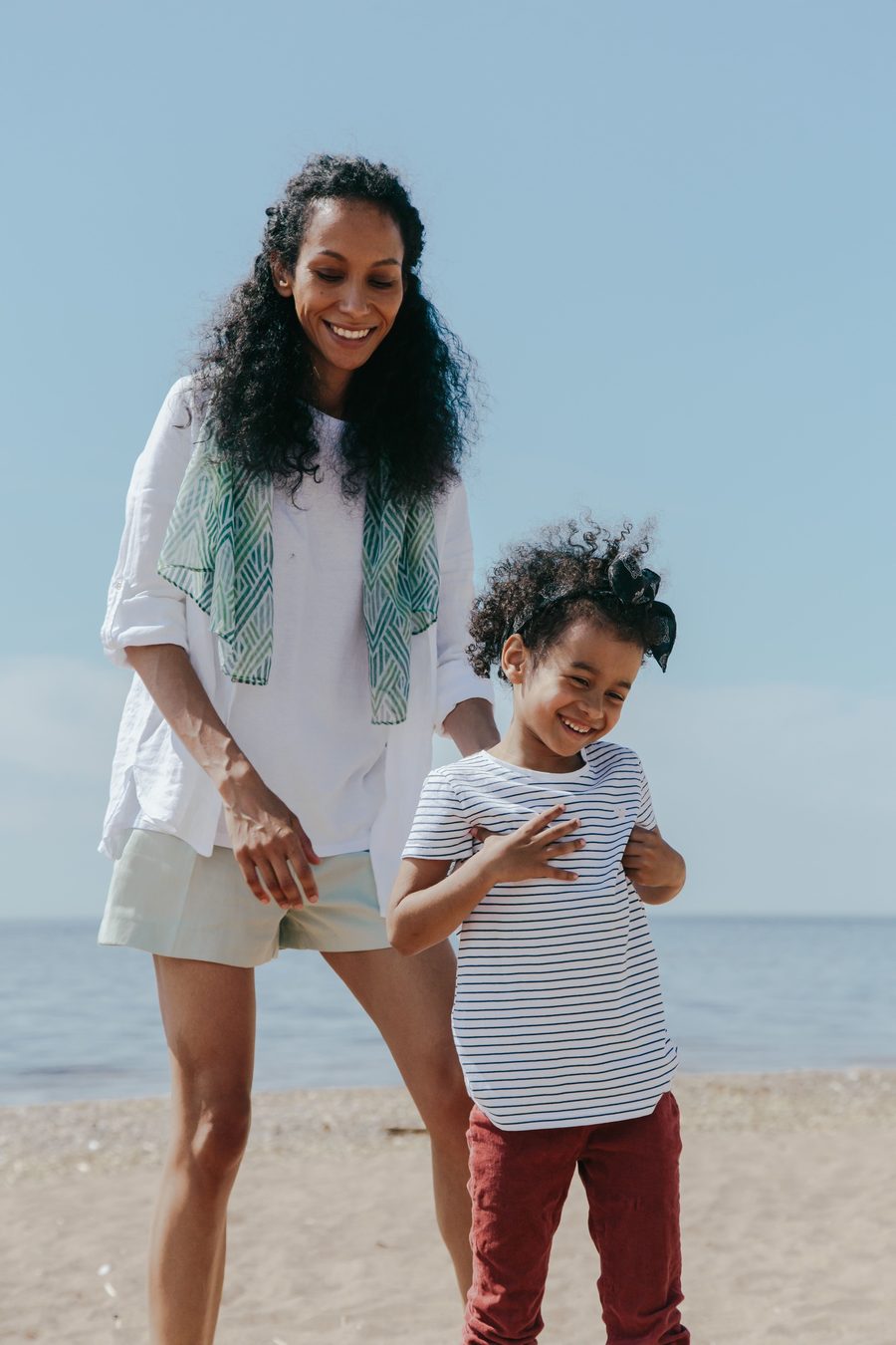 Illustrative photo of a mother and daughter walking on a beach